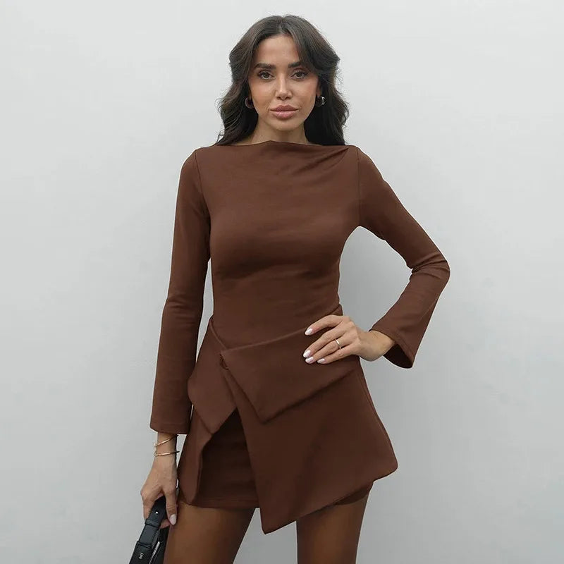 Woman wearing a brown dress against a plain background