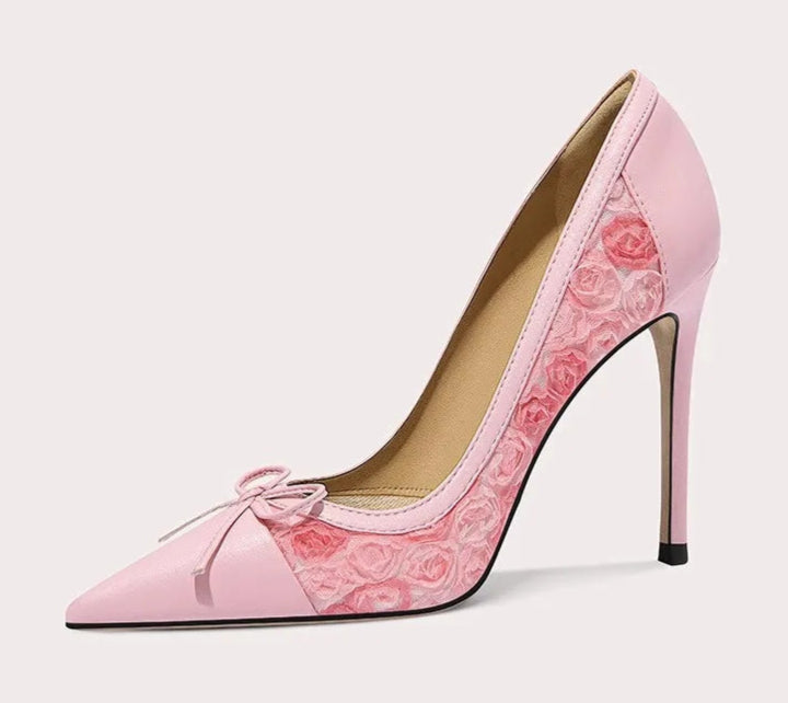 Pink high-heeled shoe with floral design on a white background