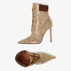 Gold beaded high-heeled boots with brown accents on a white background