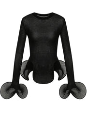 Black sheer knit top with flared pleated sleeves and ruffled hem on a mannequin