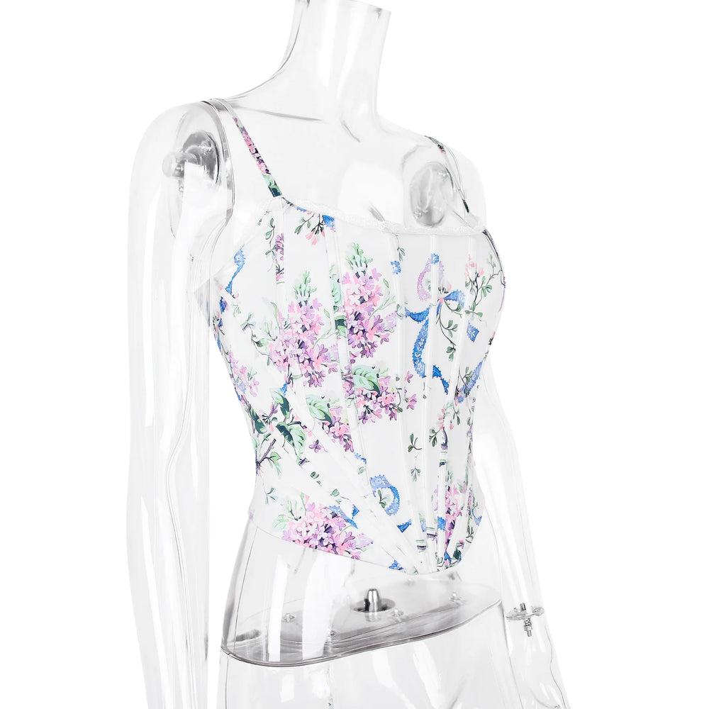 Clear plastic mannequin wearing a floral-patterned swimsuit on a white background