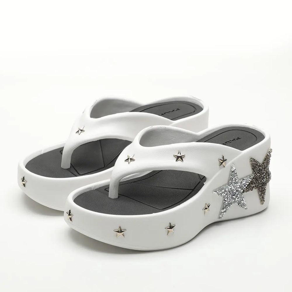 Close-up of white platform wedge heels with star details