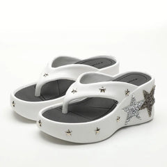 Close-up of white platform wedge heels with star details