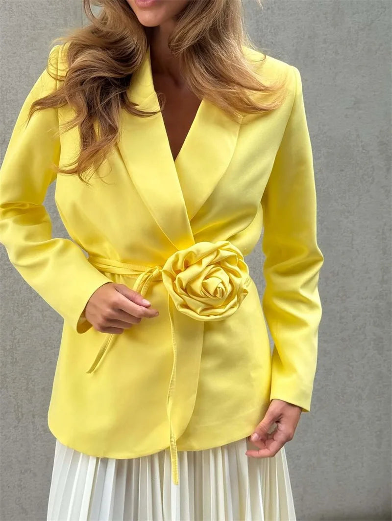 Yellow blazer with a floral detail on a gray background