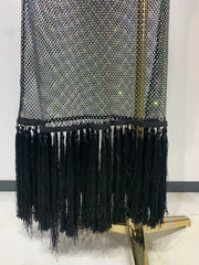 Black fringe garment on a mannequin against a white background