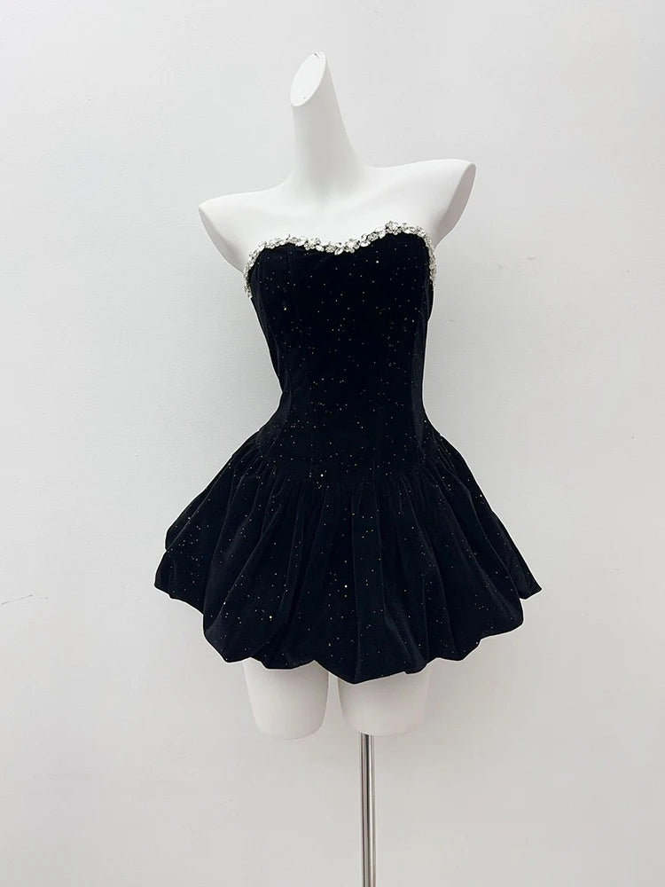 Black sparkly dress on a mannequin against a white background