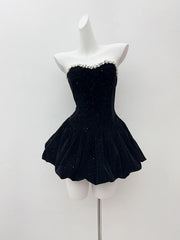 Black sparkly dress on a mannequin against a white background