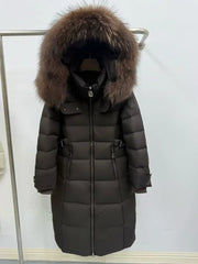 Long dark coat with fur hood on a rack against a white background