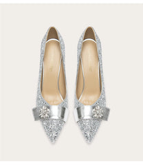 Silver glittery high heels on a white background