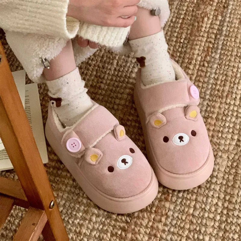 Person wearing pink cartoon bear house slippers.