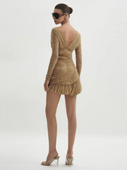 Woman wearing a beige dress with long sleeves on a white background