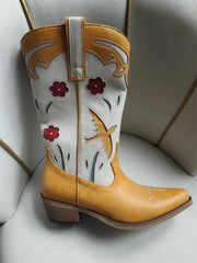 Cowboy boot with floral designs on a light gray background