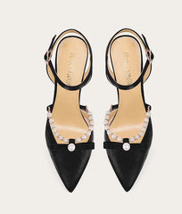 Black high-heeled shoes with embellishments on a white background