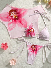 Orchid print bikini set with cover-up laid out