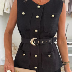 Black vest with gold buttons worn by a person, with a blurred indoor background.