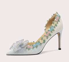 High-heeled shoe with floral design on a white background