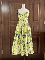 Yellow floral dress on a mannequin against a wooden door background
