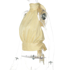 Mannequin wearing a yellow dress with a clear plastic cover on a white background