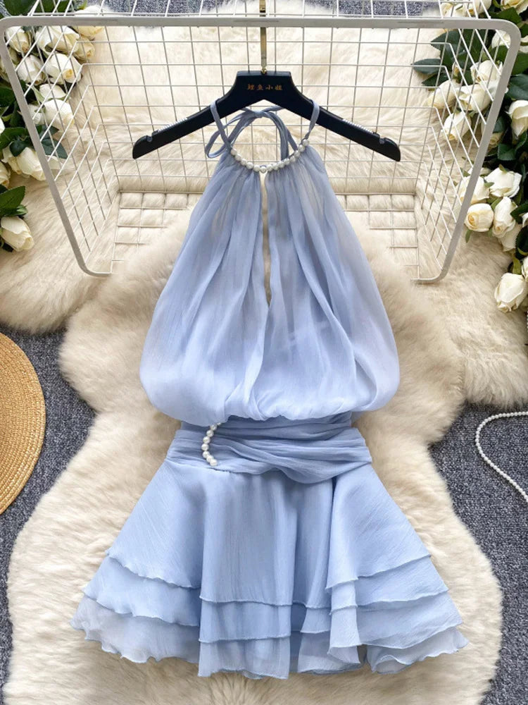 Light blue dress on a hanger with floral decorations in the background