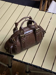 Brown leather handbag on a wooden table