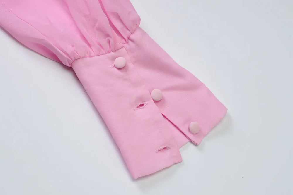 Pink baby pants with buttons on a white background
