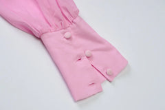 Pink baby pants with buttons on a white background
