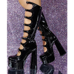 Black platform heels on a glittery purple background