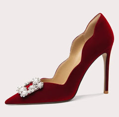 Red high-heeled shoe with decorative bow on a white background