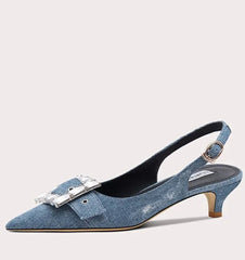 Blue denim sandal with a small heel on a light gray background