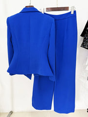 Back view of a blue double-breasted blazer with asymmetrical peplum and matching flare pants.