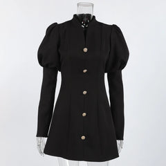 Black dress with puffed sleeves on a mannequin against a white background