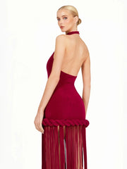 Red evening gown with fringe details on a white background