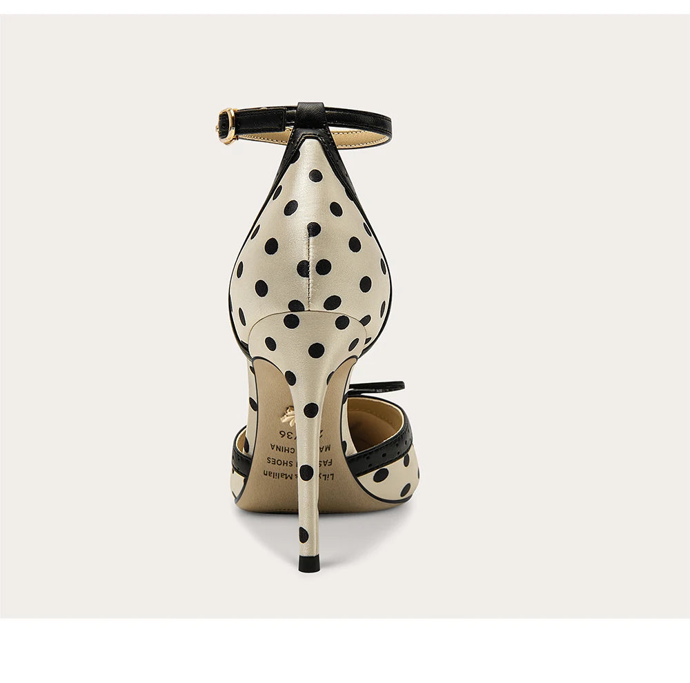 High-heeled shoe with polka dot pattern on a white background