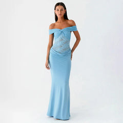 Woman wearing a light blue off-shoulder gown on a white background