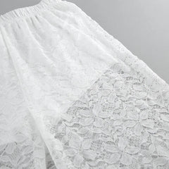 Close-up of white lace fabric on a gray background
