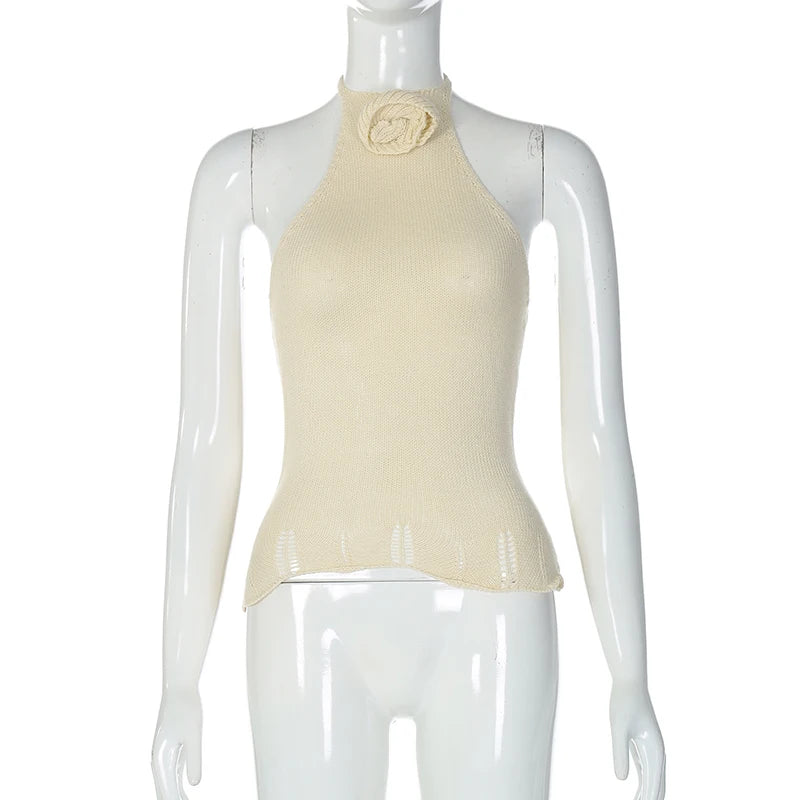 Mannequin wearing a beige halter top with a floral detail on a white background
