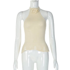Mannequin wearing a beige halter top with a floral detail on a white background