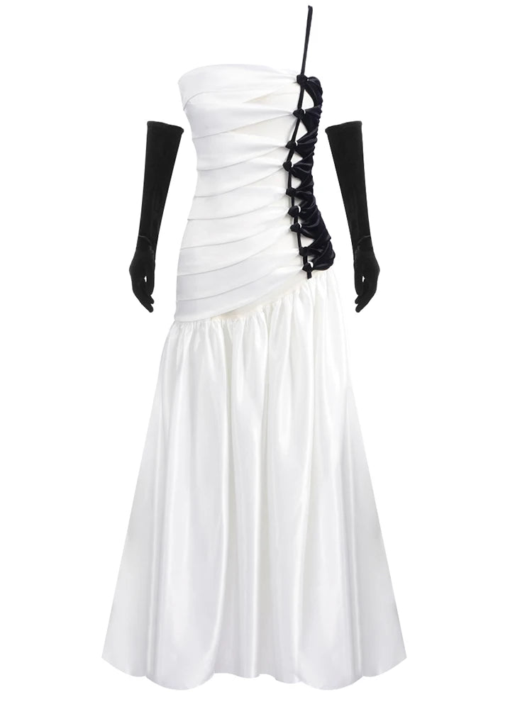 White strapless dress with black lace detailing on a white background
