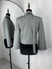 Gray blazer on a mannequin against a white background