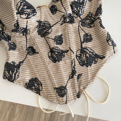 Detail of floral print and houndstooth on corset top