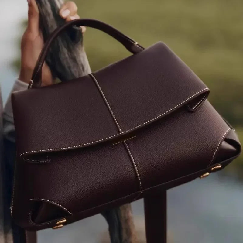 brown vegan leather top handle bag with sculptural folds