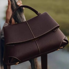 brown vegan leather top handle bag with sculptural folds