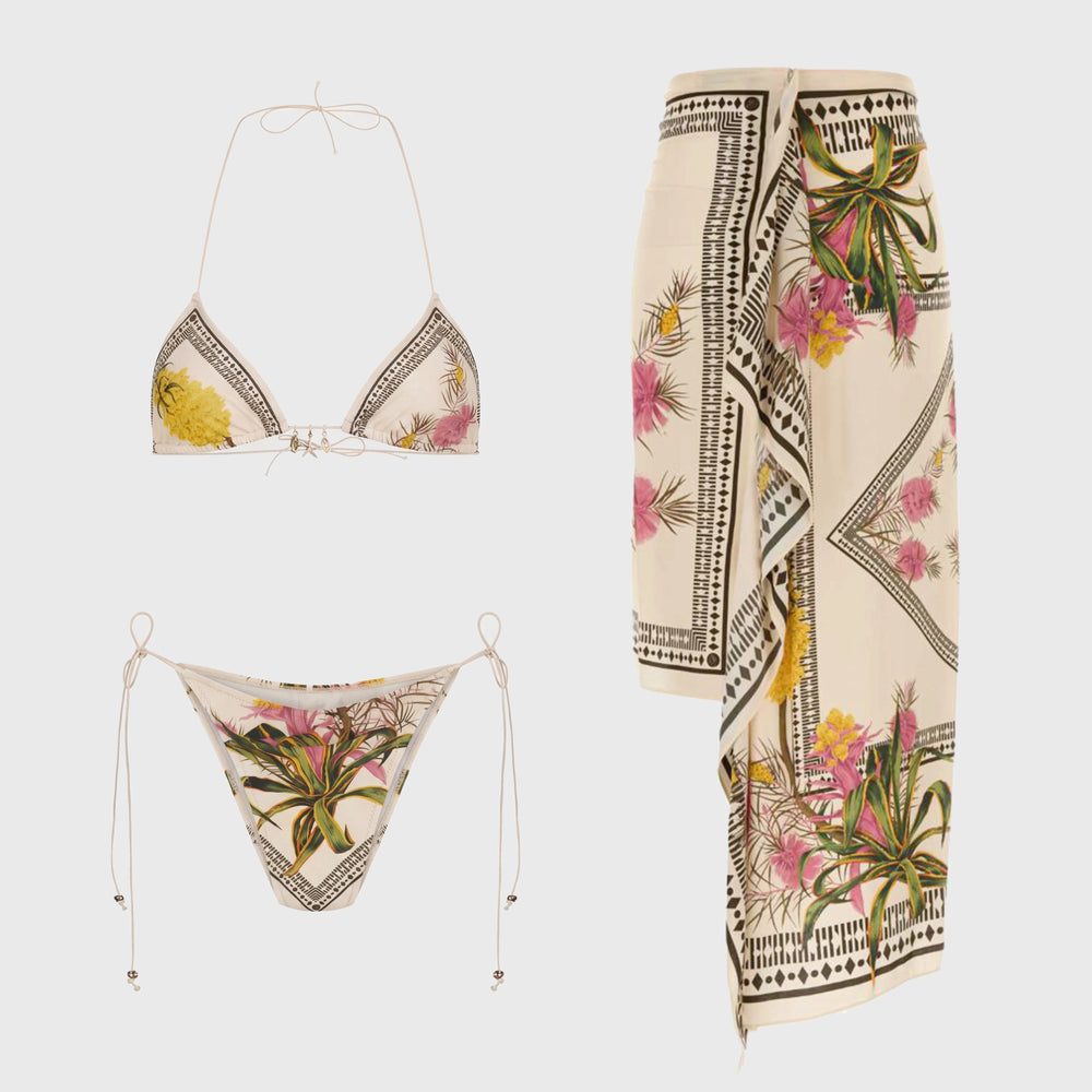 Bikini top, bikini bottom, and sarong skirt with botanical print.