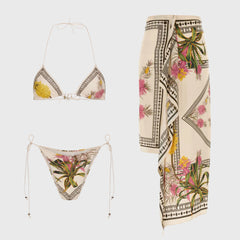 Bikini top, bikini bottom, and sarong skirt with botanical print.