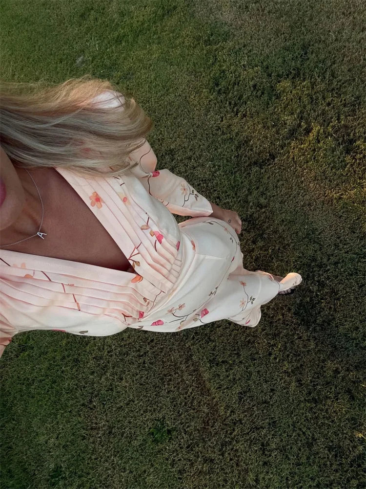Woman in a floral dress lying on grass