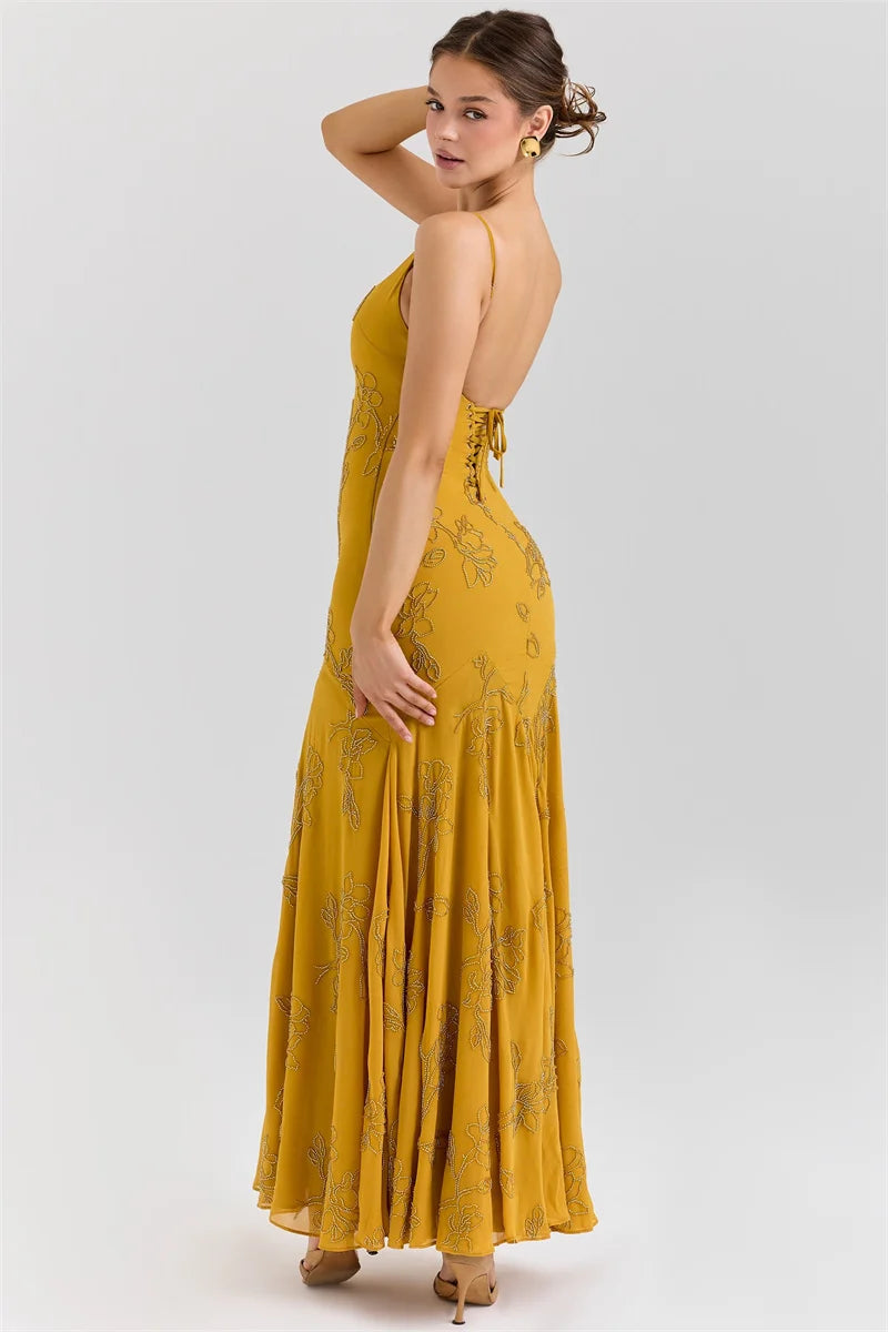 Woman wearing a yellow floral dress on a white background