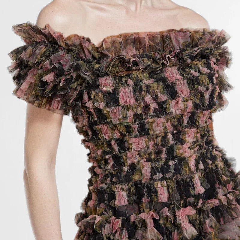 Close-up of a ruffled, off-shoulder dress with a floral pattern