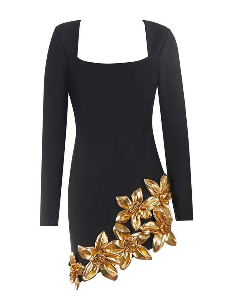 Black dress with gold floral embellishments on a white background