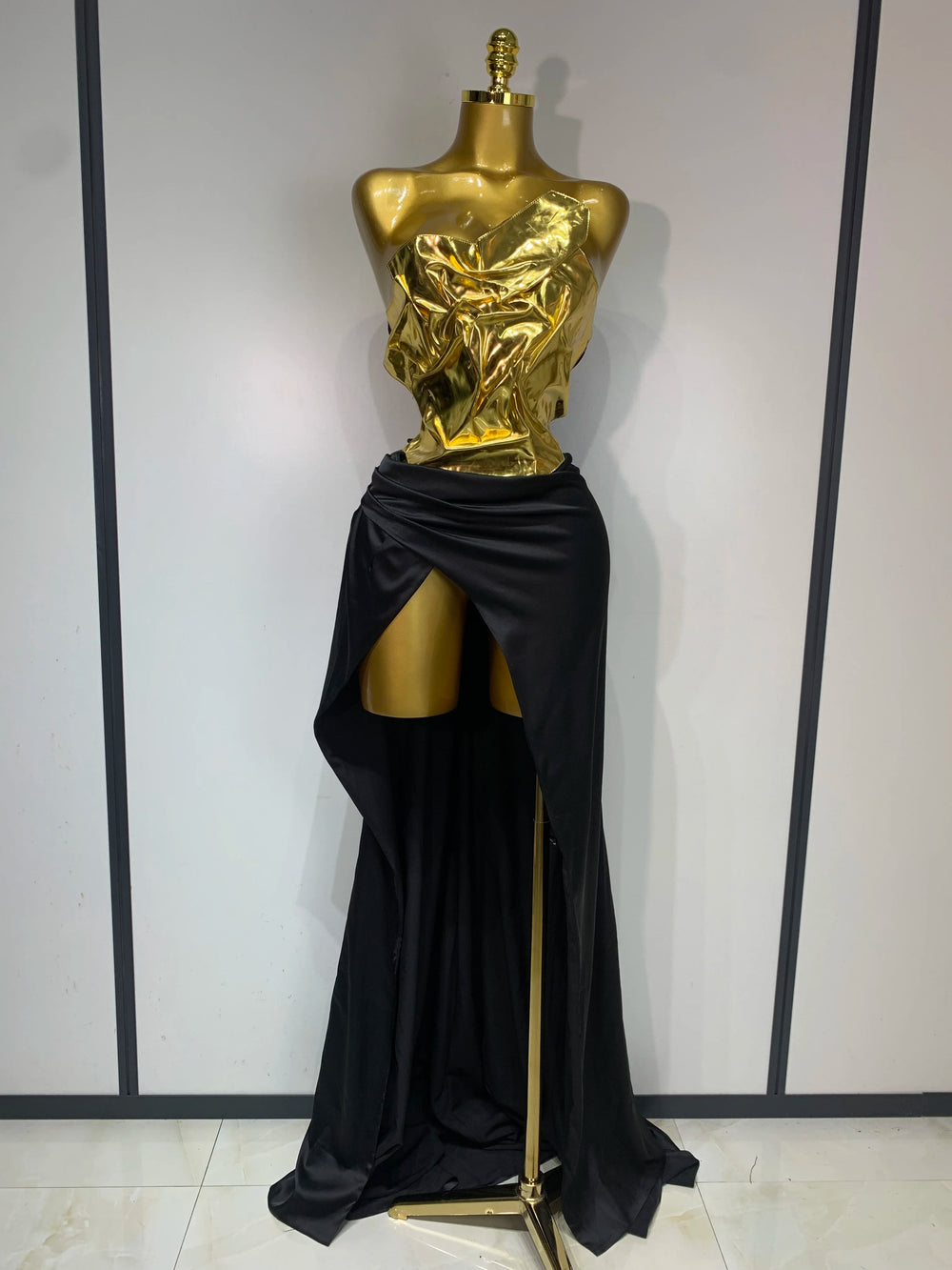 Gold metallic corset top and black draped skirt two-piece set
