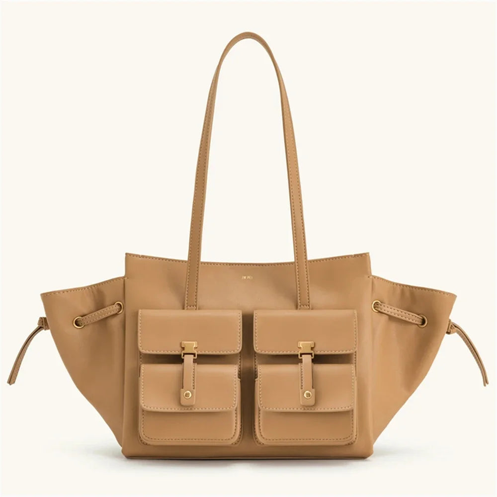 Tan handbag with multiple pockets and drawstrings on a white background
